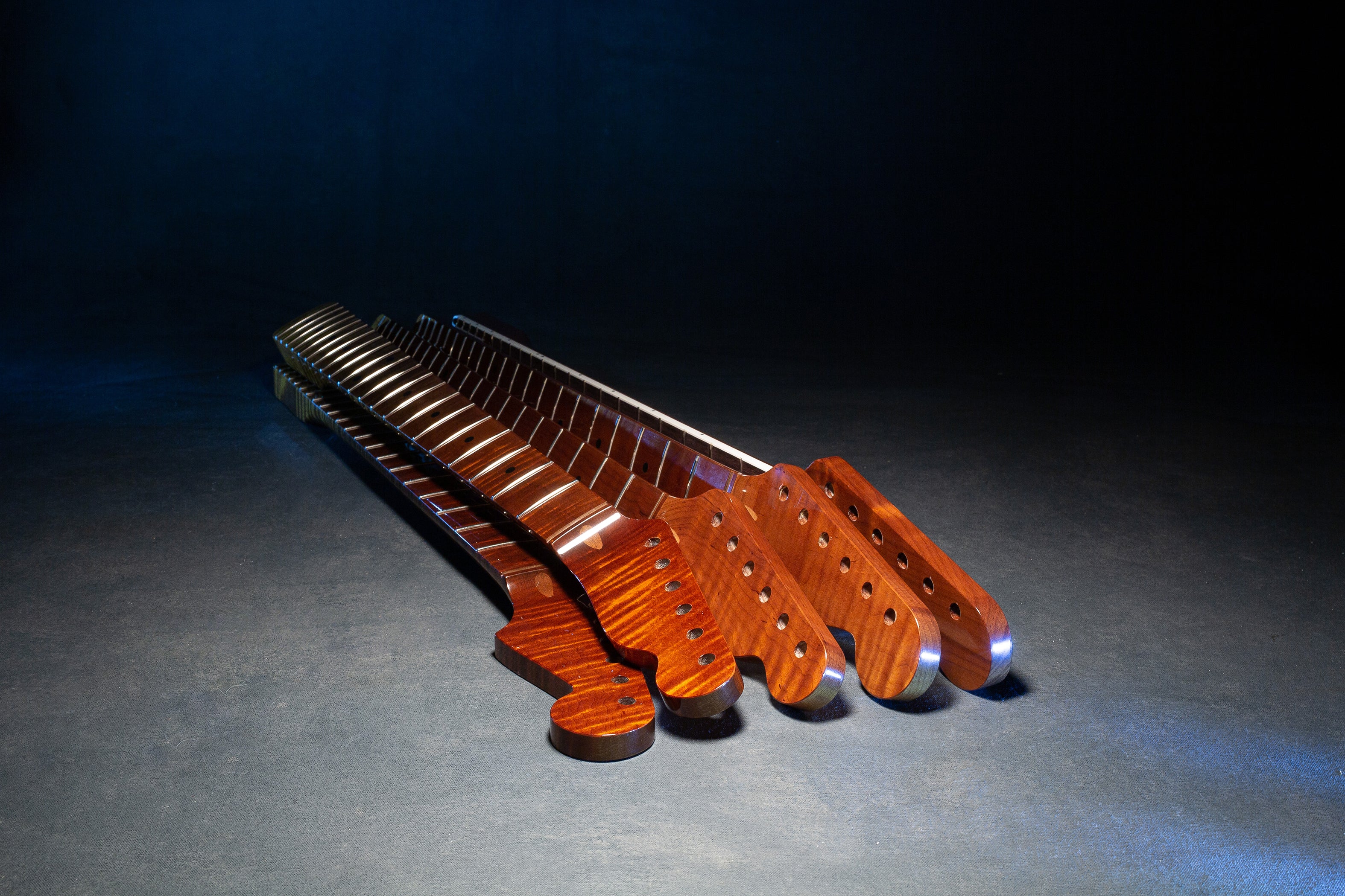 stack of premium guitar necks made with AAA+ grade wood