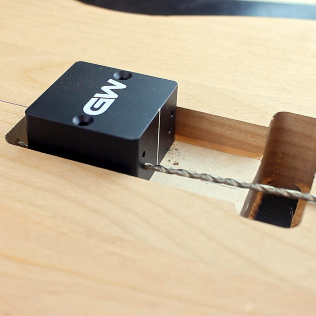 close up of a jig and drill on a guitar