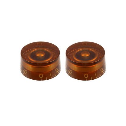 2 brownish amber colored volume knobs