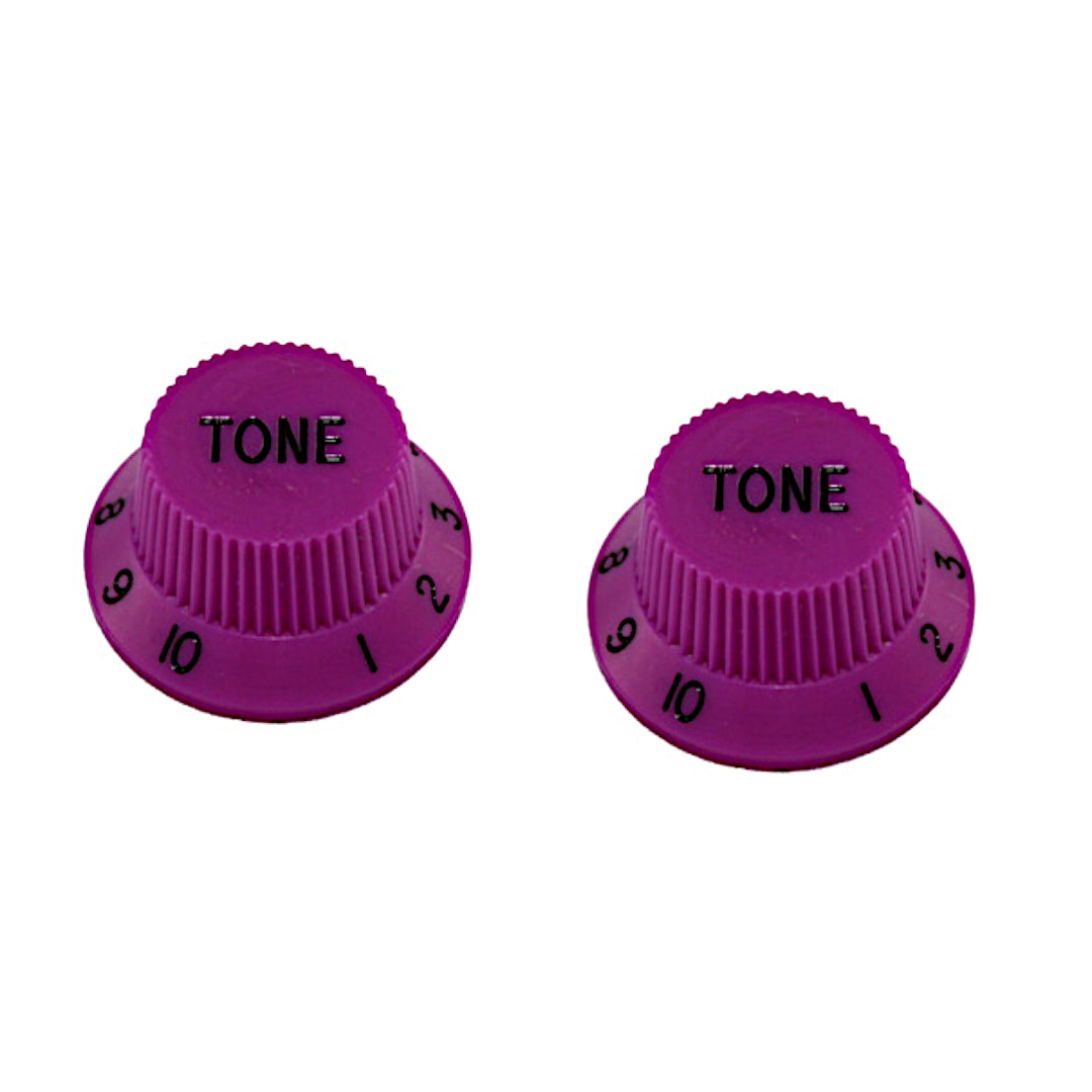 two pink strat knobs with the word "tone"